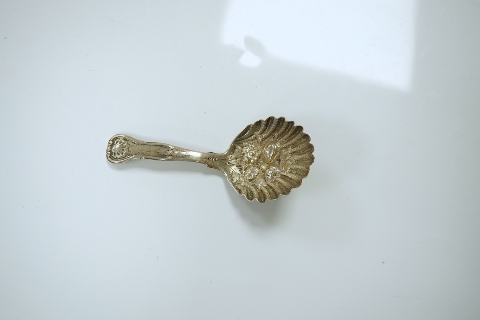 A Victorian Scottish embossed silver King's pattern caddy spoon, Millidge & Son, Edinburgh, 1854, 10.5cm, together with a later silver caddy spoon, a silver Hanau spoon and three other continental white metal spoons incl